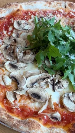 Cozy interior of Pizza Yos, featuring a funghi pizza and chili oil, perfect for weekend dining in St Albans.