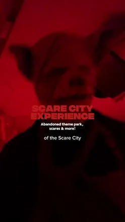 Visitors enjoying spooky attractions at Scare City, Camelot Theme Park, Manchester during Halloween festivities.