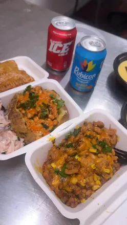 Enjoying cheese and beans, Cajun chicken jacket potatoes, and desserts at Roti Ghar in Birmingham.