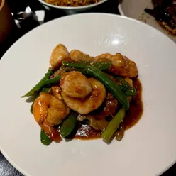 Diners enjoying satay wonton, shiu mai, and wine at Opium, a hidden gem restaurant in Glasgow for delicious Asian cuisine.