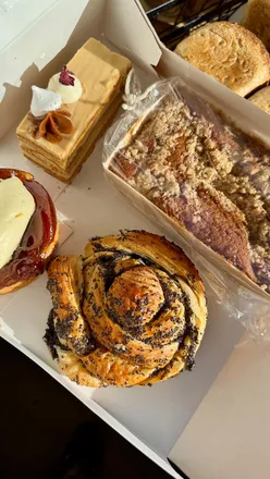 Delicious pastries at Savour Bake Café in Gateshead, featuring croissants, tartes Tatin, and honey cake delights.