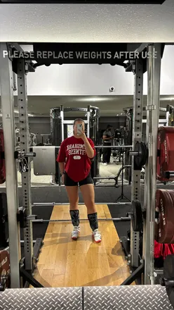 Fitness enthusiasts doing a 20-minute EMOM workout with row, snatch, and wall balls for a quick challenge.