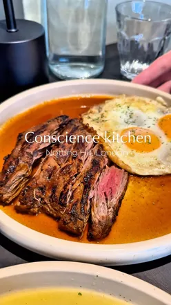 Delicious grilled chicken and steak dishes at Conscience Kitchen, a hidden gem in Notting Hill with a friendly vibe.