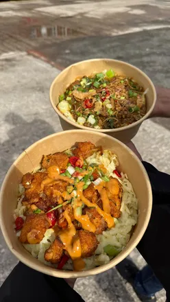 Delicious beef curry and salt & pepper jacket potatoes at Hustle n Spud in Oldham, topped with fresh ingredients.