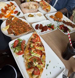 Delicious Turkish dishes like sucuk, lahmacun, and pide enjoyed at Lezzet in Cardiff, a beloved local favorite.