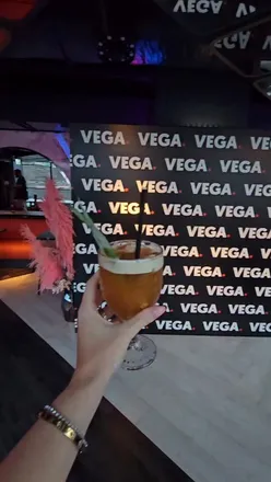 Group enjoying cocktails and food at Vega Glasgow, featuring views and bowling for a fun night out.