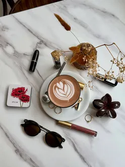 Stylish autumn outfit featuring cozy layers and a coffee in a Leeds cafe, capturing seasonal vibes.