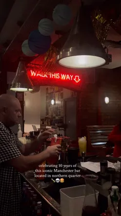 Cozy interior of The Pen and Pencil bar in Manchester's Northern Quarter, featuring cocktails, food specials, and lively events.
