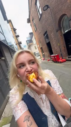 Delicious custard tarts on display at a bakery in Manchester, tempting foodies with their creamy goodness.