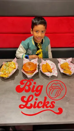 Kids enjoying mouth-watering burgers and colorful shakes at Big Licks, a fun spot in Manchester.