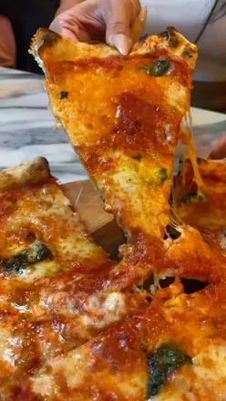 Enjoying crispy pizzas and homemade sauces at Micky Marzano's, featuring unique flavors like saffron-inspired 'The Alchemist'.