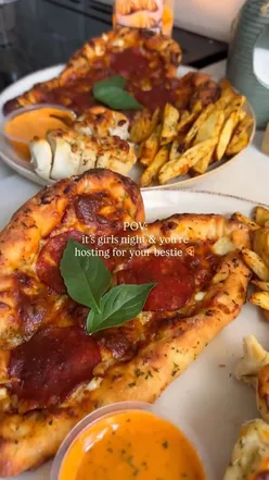 Homemade pizza dinner with white wine and Caesar dip, celebrating a friend's upcoming birthday.