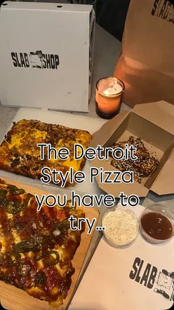 Delicious Detroit-style deep pan pizzas at Detroit Slab Shop in Edinburgh with vibrant toppings and garlic-chili oil.