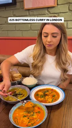 Customers enjoying bottomless curry with side dishes at Rosa's Thai in London, featuring various curry options.
