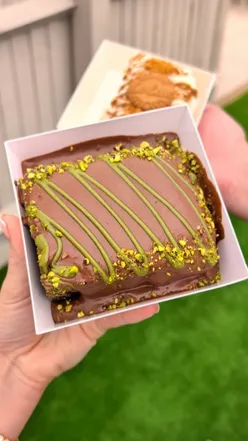 Delicious cakes from @dudecake_ on display in Bristol, enticing dessert lovers with vibrant flavors and designs.