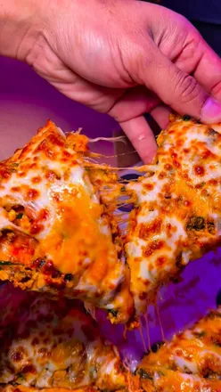 Delicious burgers and pizzas served at Crown Chaos Kitchen in Bradford, showcasing vibrant interiors and a lively atmosphere.