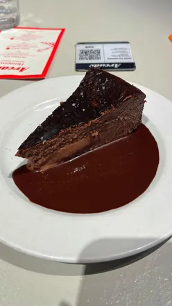 Delicious chocolate torte with sauce and salt flakes at Solis Grill, a must-try dessert in London.