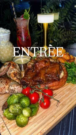 Delicious fully halal Sunday roast featuring succulent meats and traditional sides at a vibrant restaurant.