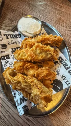 Giant frickles with blue cheese sauce from St. Luke's in Glasgow, perfect for foodies exploring the local scene.