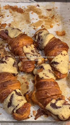 Enjoying the original cookie croissant, or 'crookie,' at Maison Louvard in Paris, known for its crispy exterior and soft center.