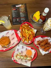 Juicy 'Po-Po' burger and gooey mozzarella sticks at Sin City Social, Liverpool, with vibrant decor and delicious drinks.
