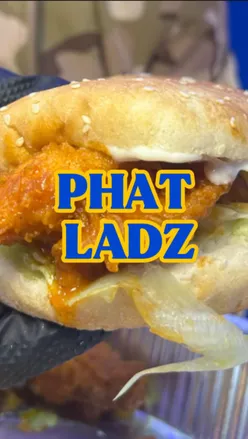 Student enjoying a delicious food box with a Nashville burger, tenders, and peri peri fries at Phat Ladz, East London.