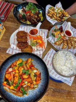 Delicious spread of Thai cuisine at Olive & Thai in Leeds, featuring sweet and sour chicken and teriyaki roast duck.