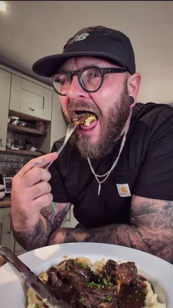 Delicious braised oxtail dish topped with rich sauce, perfect for comfort food lovers, served with creamy mash.