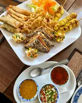 Delicious mixed starter platter featuring Pad Thai, tamarind duck, and Massaman curry at Siam Thai, Chipping Sodbury.