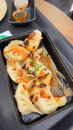 Delicious dishes enjoyed in Amsterdam, including dumplings, burgers, and croissants from local favorites.