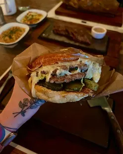 'Delicious burgers served at Flat Iron Steak, enticing food lovers to indulge in a tasty dining experience.'