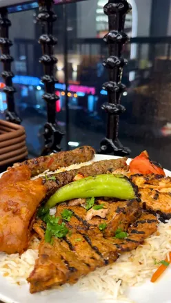 Delicious Pakistani dishes at CZN Burak Bradford, featuring crispy masala fish and hearty lamb karahi.