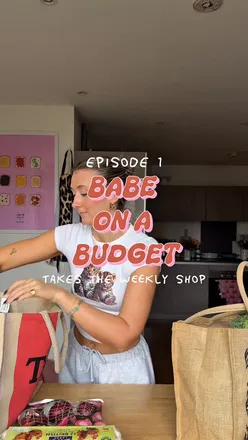 Girl showcasing a £35 weekly vegetarian food shop with various ingredients for budget-friendly meals.