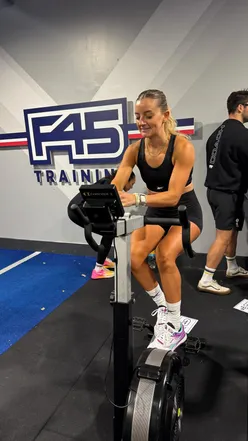 Competitor showcasing Reebok Nano X5 shoes during an F45 Playoffs workout, celebrating a third-place finish.