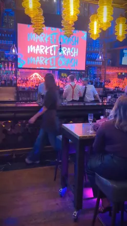 People enjoying cocktails during the energetic 'Stocks on the Rocks' event at Manahatta, Sheffield city centre.