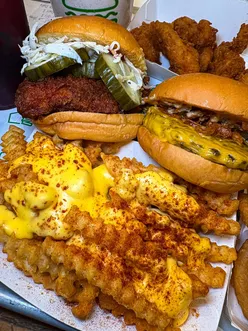 Shake Shack Cardiff's spicy hot chicken burger, cheese fries, and carrot cake shake in a vibrant dining experience.