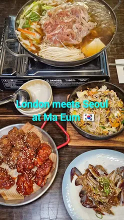 Diners enjoying a variety of Korean dishes at Maeum Restaurant in Southwest London.