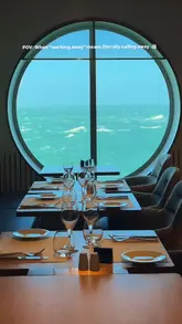 Person enjoying coffee and buffet on Brittany Ferries while working remotely with a view of blue waters.
