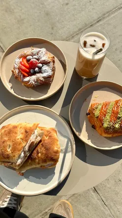 Interior of 60 Degrees Coffee in Victoria, showcasing stunning aesthetics, sandwiches, and pastries including pistachio pain au chocolat.