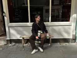 People enjoying a scenic autumn day in London with vibrant fall foliage in the background.