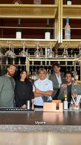 Uyare team in Leeds discussing favorite dishes and cocktails, featuring a vibrant dining atmosphere and cocktails.