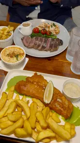 Enjoying a lively comedy night at Eastern Jam with delicious fish and chips in Birmingham.