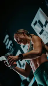 HYROX-style workout in a local gym: 20 wall balls, 12.5m sled pull, 500m run - vibrant fitness scene for local search.