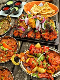 Giveaway announcement for a meal for 4 at The Covered Wagon Coventry with Indian cuisine and mixed grills.