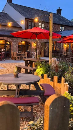 Group enjoying Southern BBQ fare at Hickory's Smokehouse, Cardiff, basking in a warm, inviting atmosphere.