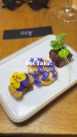 Guests enjoying an Ibiza-themed birthday dinner, savoring vibrant dishes at a cozy supper club celebration.