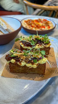 Delicious plant-based dishes at Mallow London, including mushroom ravioli and ginger sticky toffee, delighting diners.