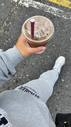 Two workout buddies smiling after completing a challenging partner workout at The Hybrid Games in a gym setting.