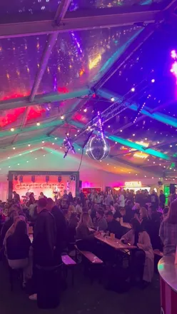 Enjoying £5 cocktails at Edinburgh Cocktail Week, with live music and pop-up bars in a vibrant atmosphere.