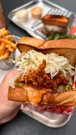 Delicious Nashville hot fried chicken sandwich with pickles, slaw on brioche toast at Lucky's in Covent Garden, London.